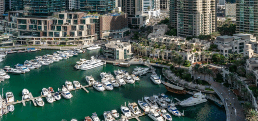 Sunset over the Dubai Marina waterfront with yachts in the harbour