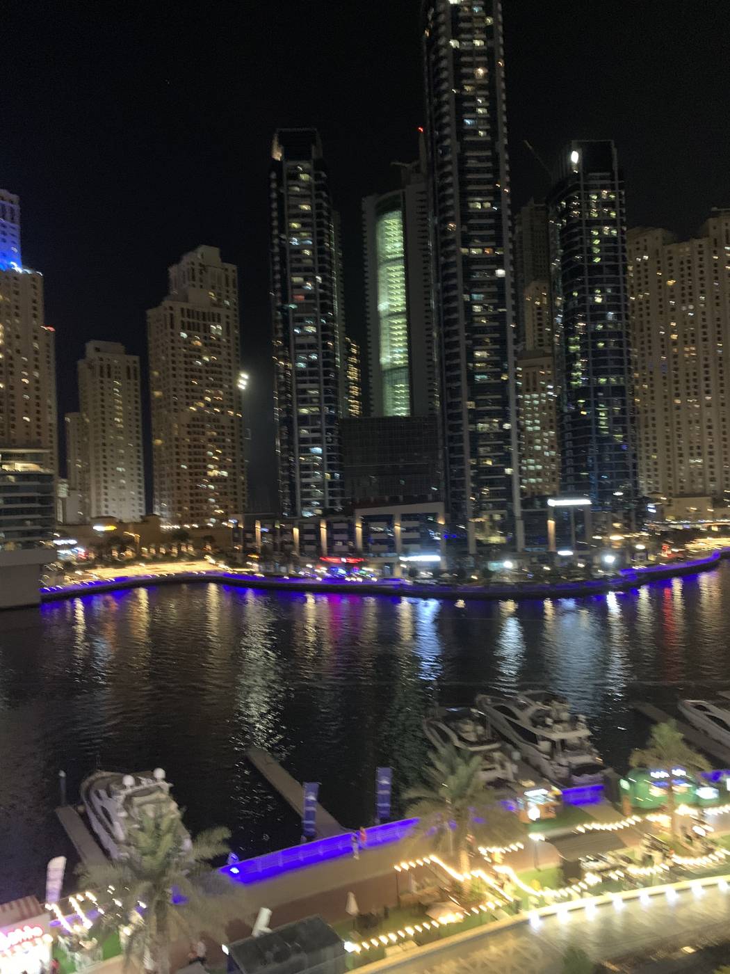 Dubai Marina canal at night with illuminated skyline